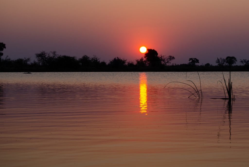 Sunset while on a mokoro at the Okavango Delta in Botswana - The Solivagant soul